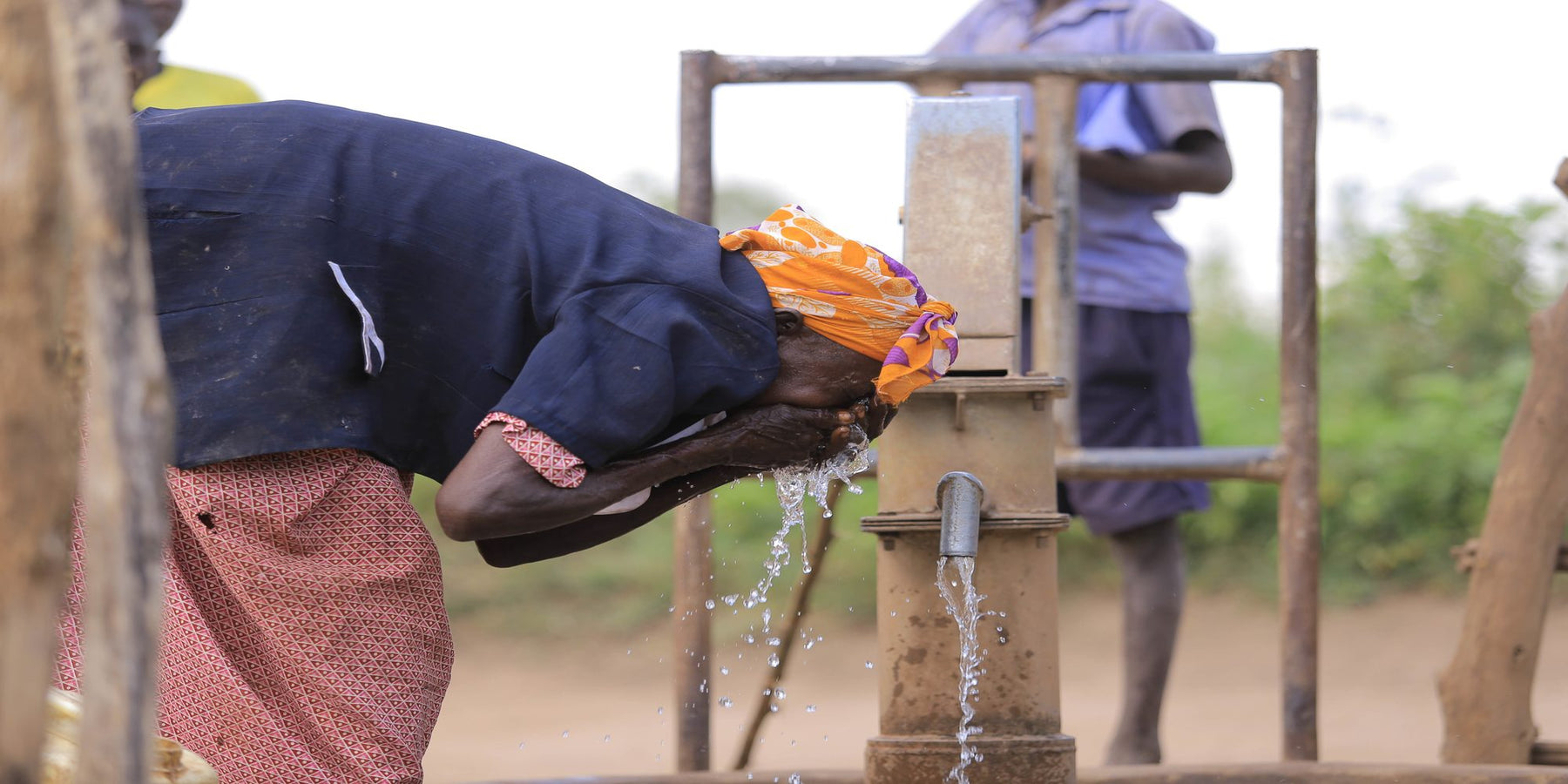 Women at a community borehole in Uganda