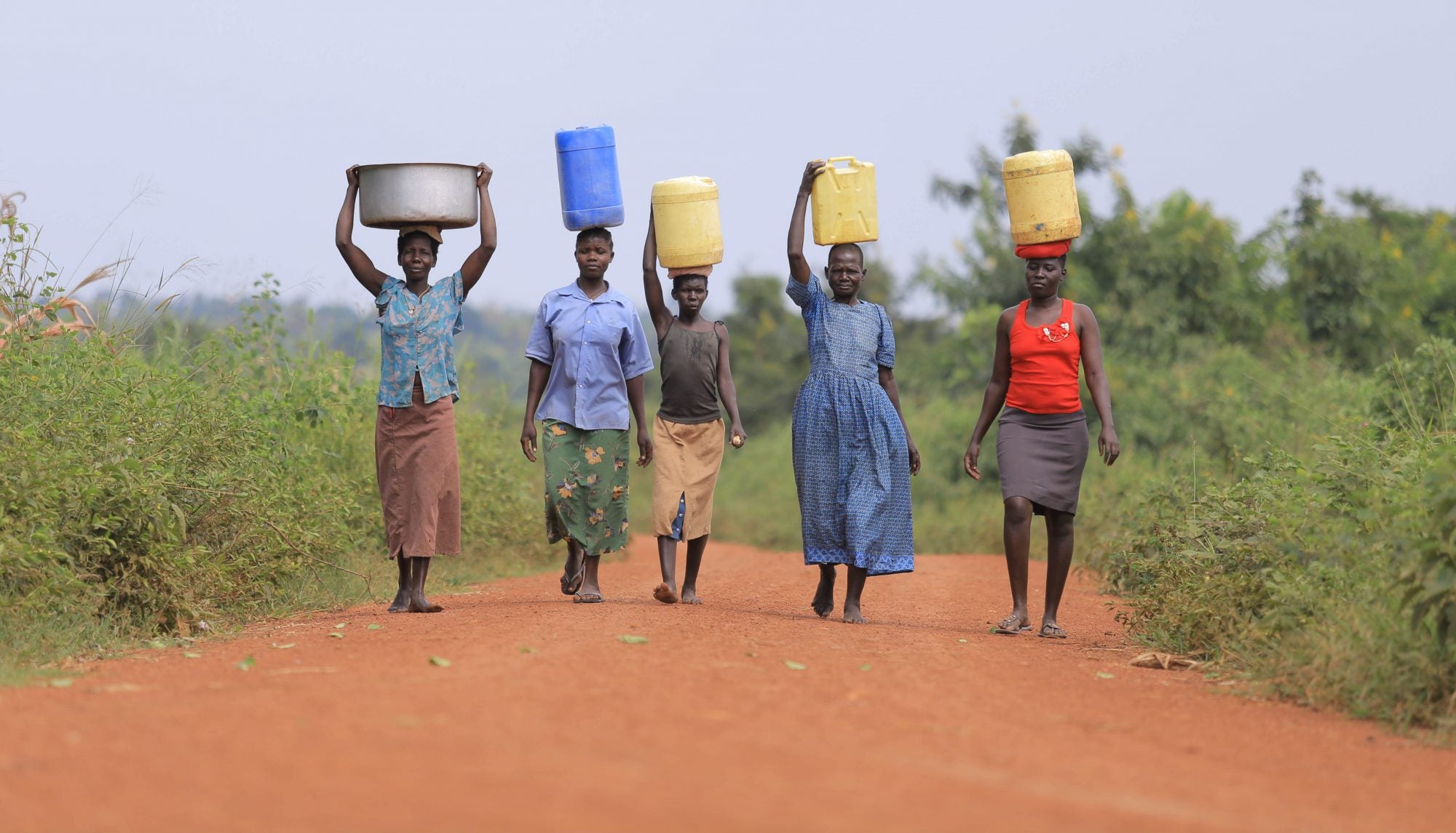 Women carrying water containers in a CO2balance project area