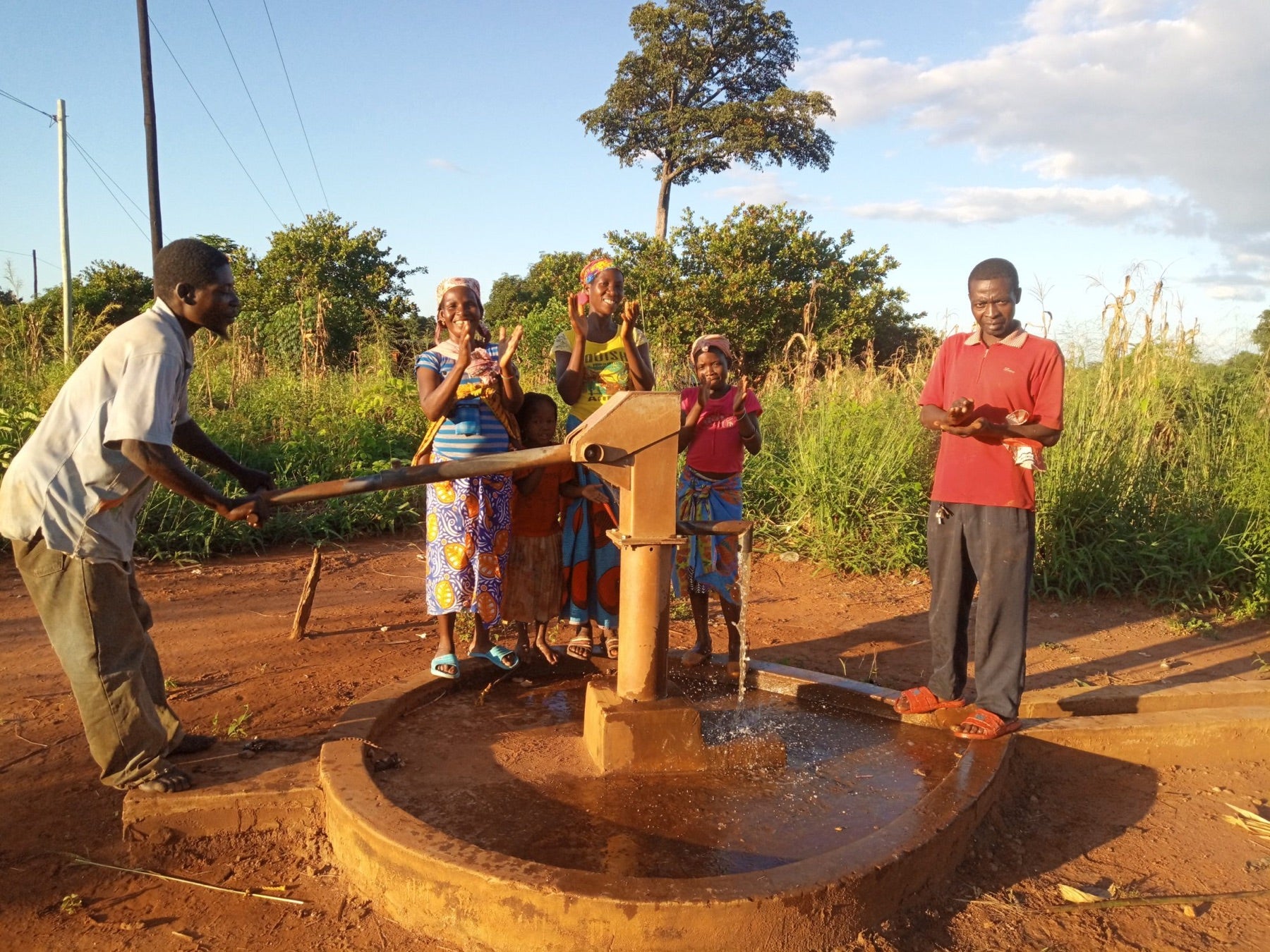 Community members using a restored handpump at a CO2balance safe water project