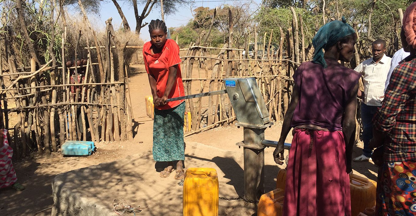 Women collecting water from a community handpump in Ethiopia
